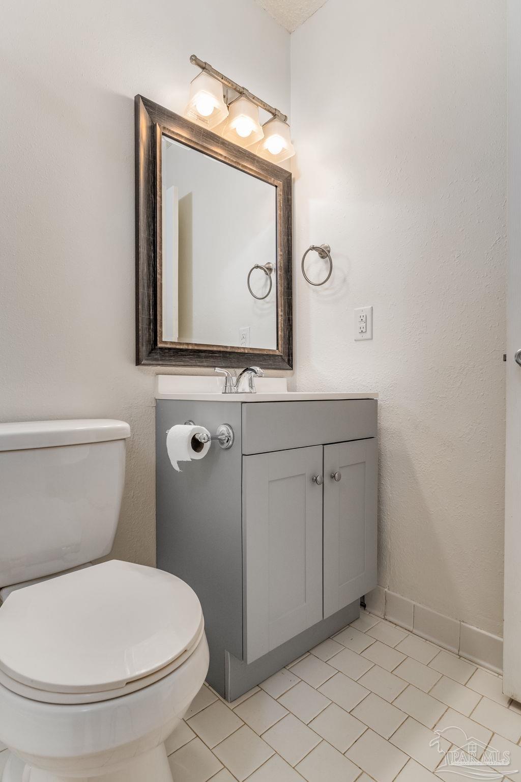 1422 Starlight Drive Cantonment, FL 32533 - Photo 26 of 49 a bathroom with a toilet a sink and mirror