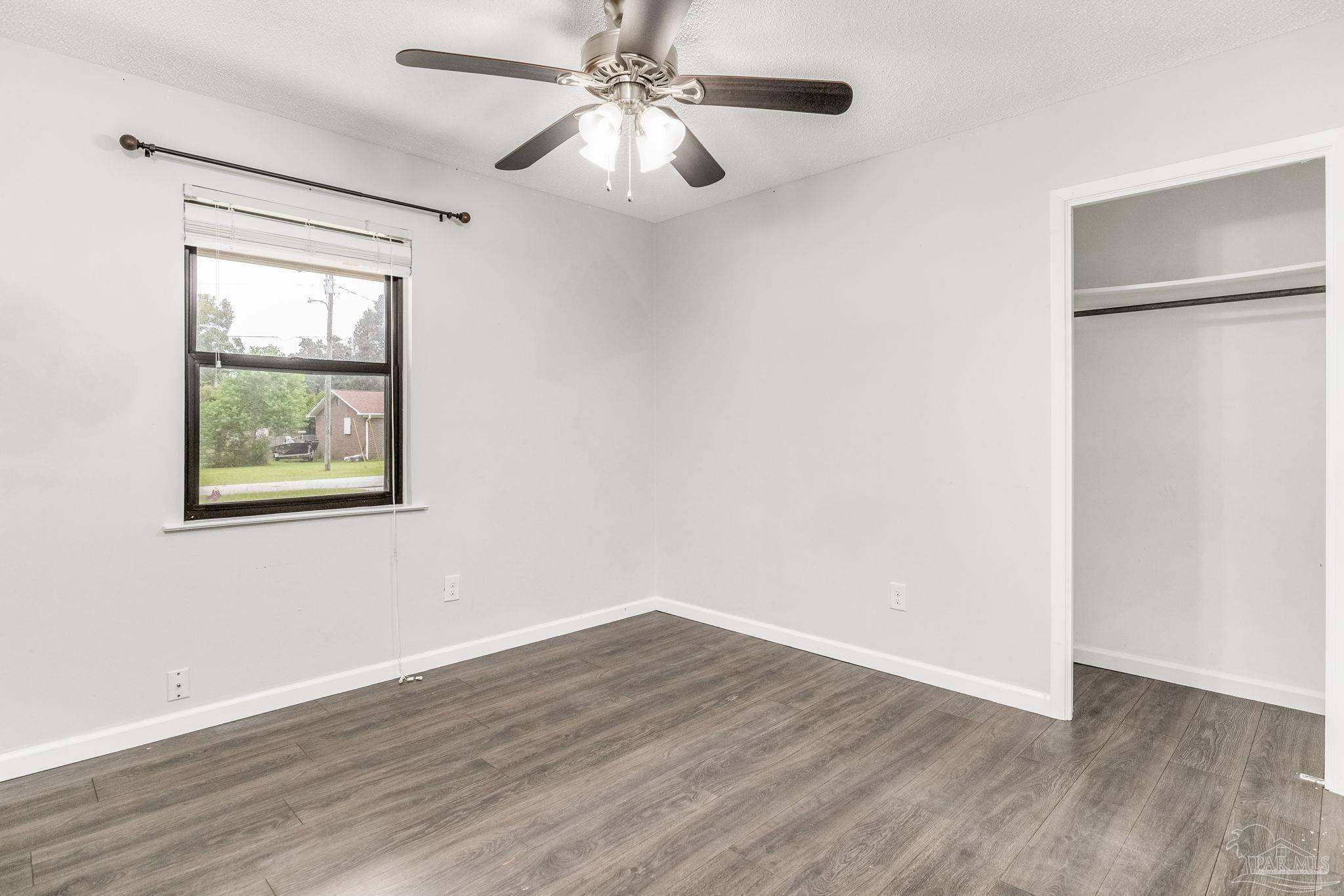 1422 Starlight Drive Cantonment, FL 32533 - Photo 28 of 49 a view of an empty room with wooden floor and a window