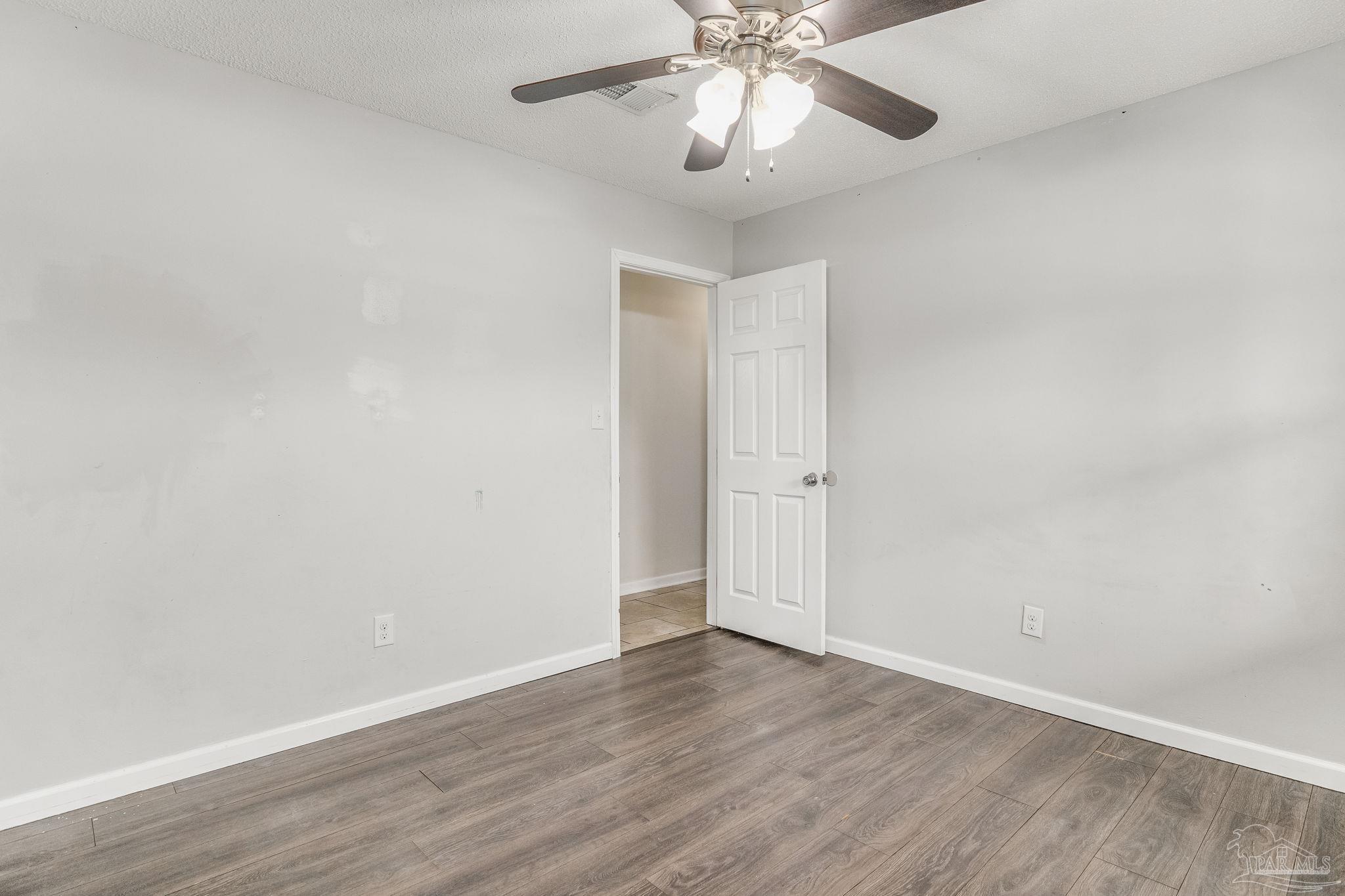 1422 Starlight Drive Cantonment, FL 32533 - Photo 30 of 49 a view of an empty room with wooden floor