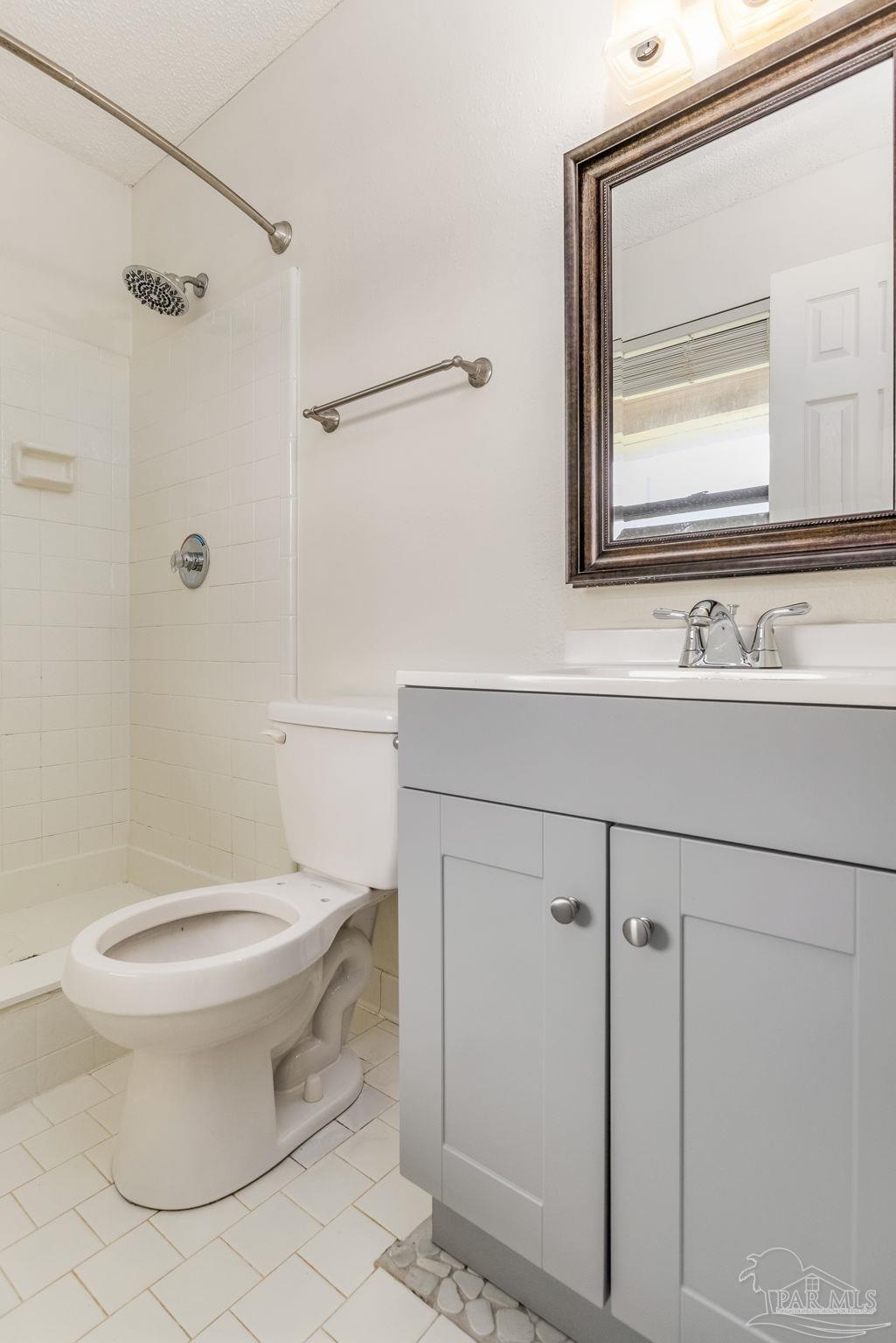1422 Starlight Drive Cantonment, FL 32533 - Photo 31 of 49 a bathroom with a toilet sink and mirror