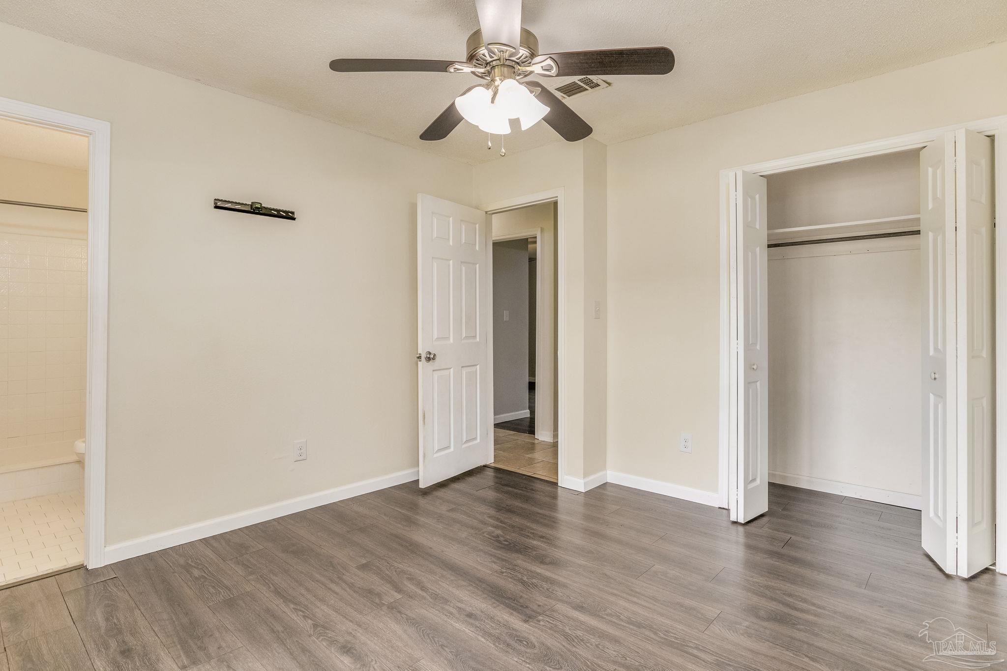 1422 Starlight Drive Cantonment, FL 32533 - Photo 36 of 49 a view of an empty room with wooden floor