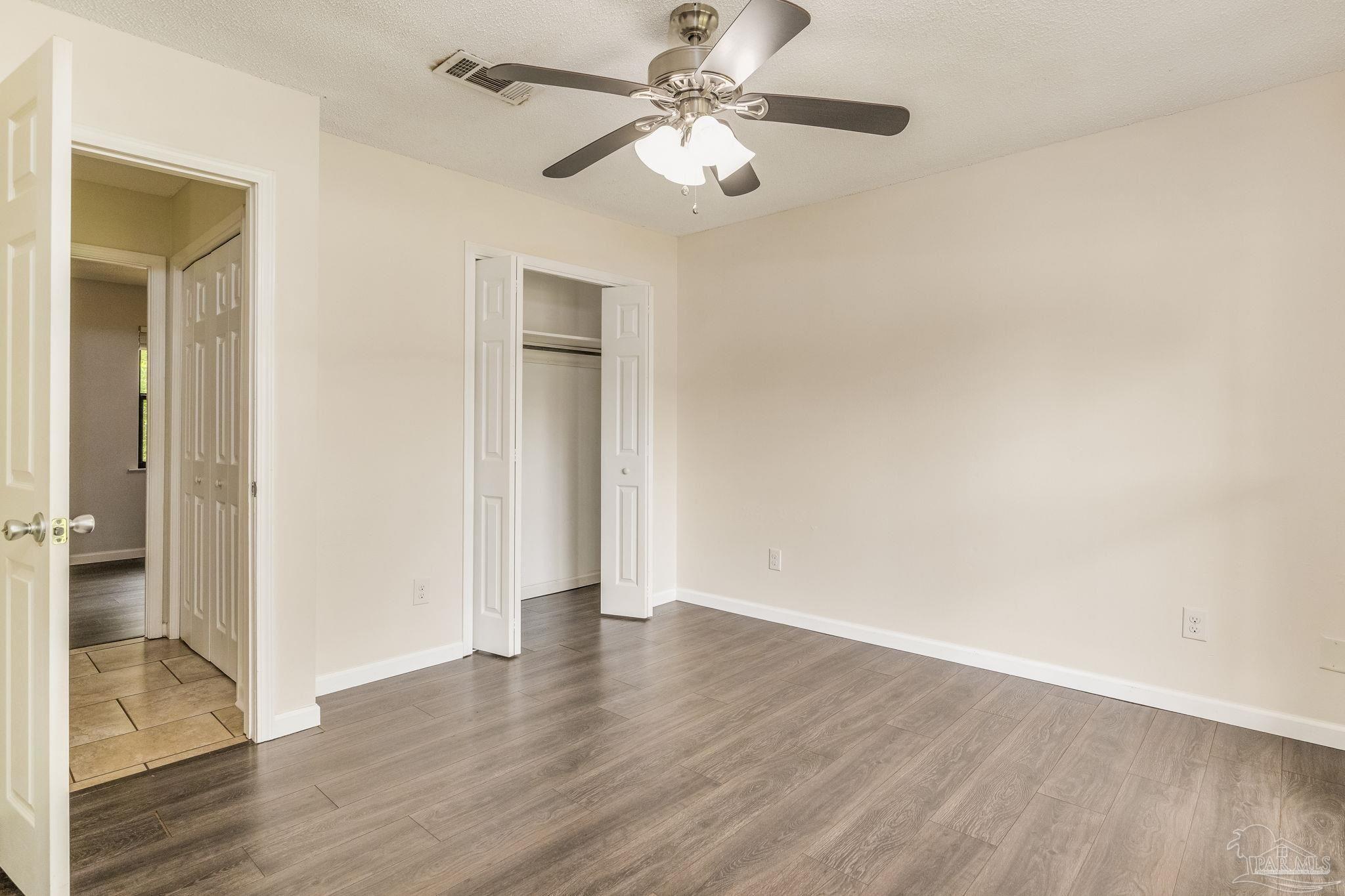 1422 Starlight Drive Cantonment, FL 32533 - Photo 37 of 49 a view of an empty room with wooden floor