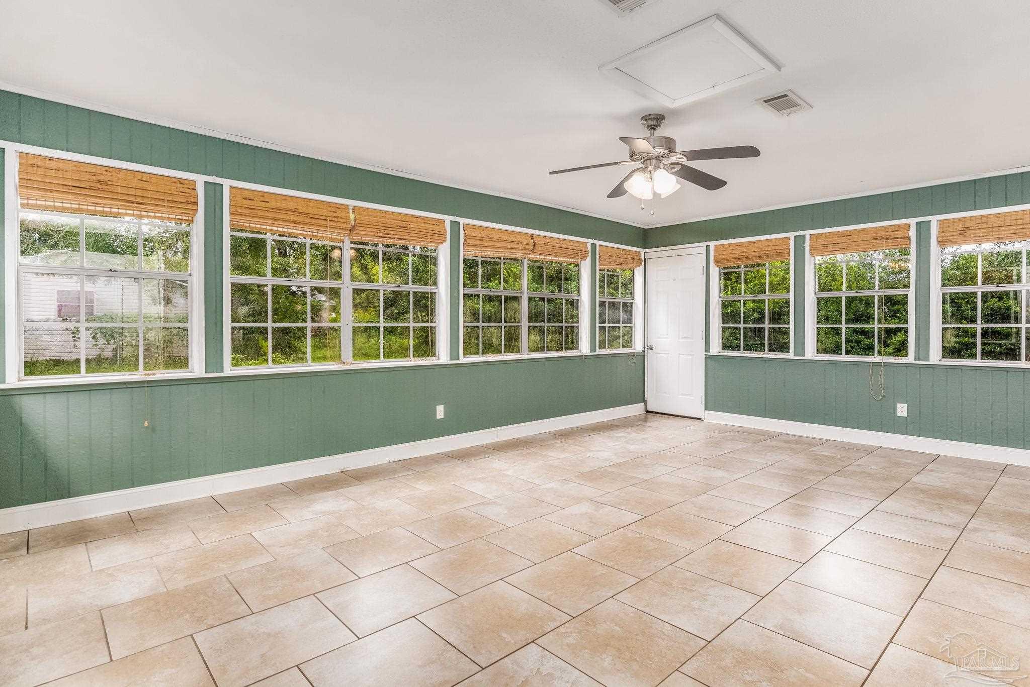 1422 Starlight Drive Cantonment, FL 32533 - Photo 4 of 49 a view of an empty room with a window and kitchen view