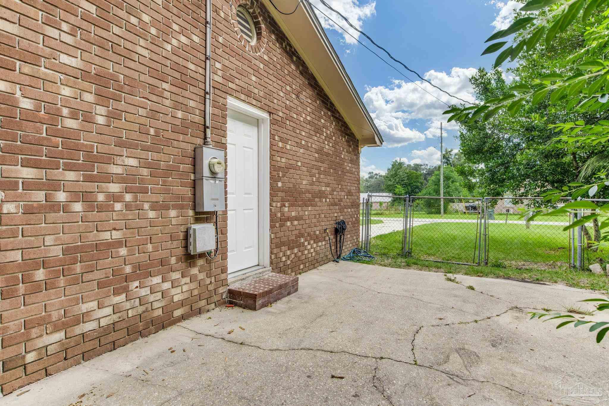 1422 Starlight Drive Cantonment, FL 32533 - Photo 49 of 49 a view of a brick house with a small yard