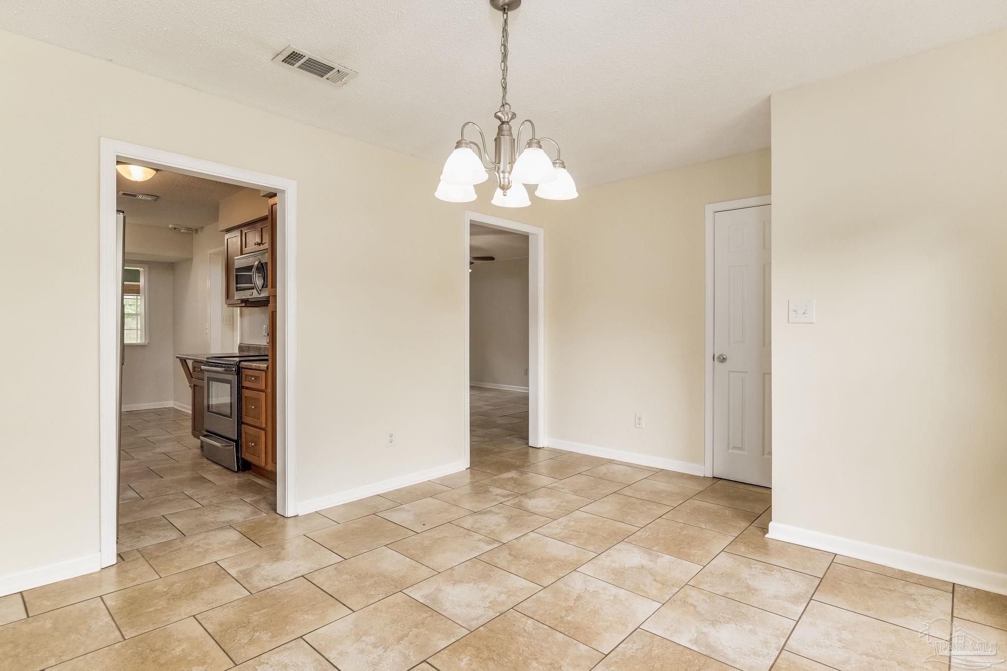 1422 Starlight Drive Cantonment, FL 32533 - Photo 8 of 49 a view of a hallway with wooden floor and a dining room