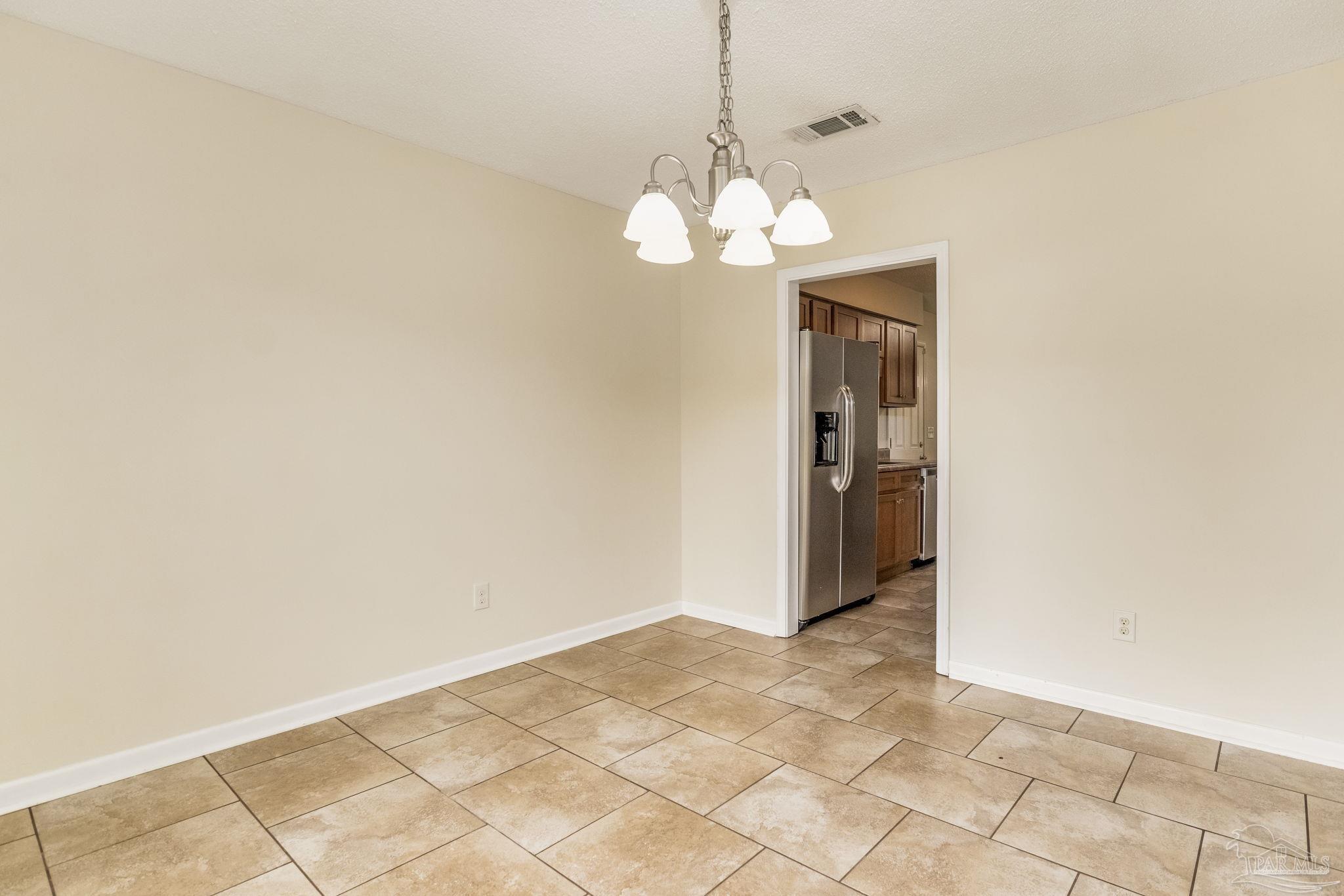 1422 Starlight Drive Cantonment, FL 32533 - Photo 9 of 49 a view of a chandelier fan and a window