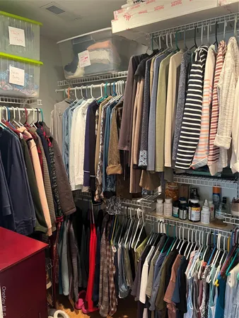 a view of a living room with a floor to ceiling window and potted plants