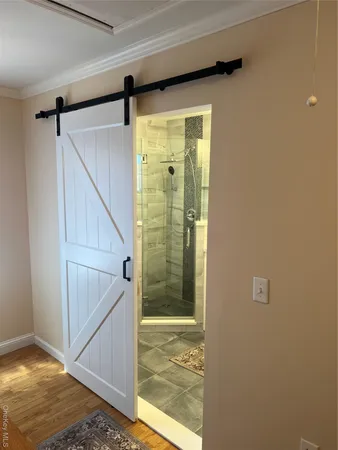 a view of a patio with table and chairs with wooden floor and floor to ceiling window