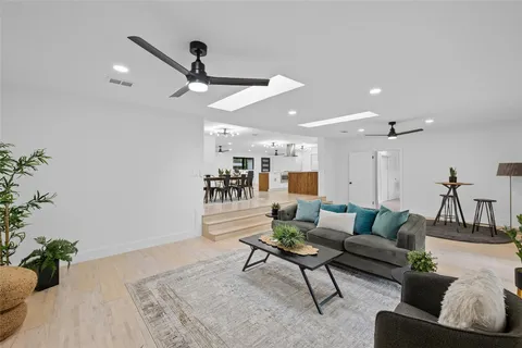 a living room with furniture and a ceiling fan