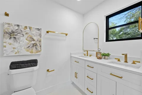 a bathroom with a double vanity sink and mirror