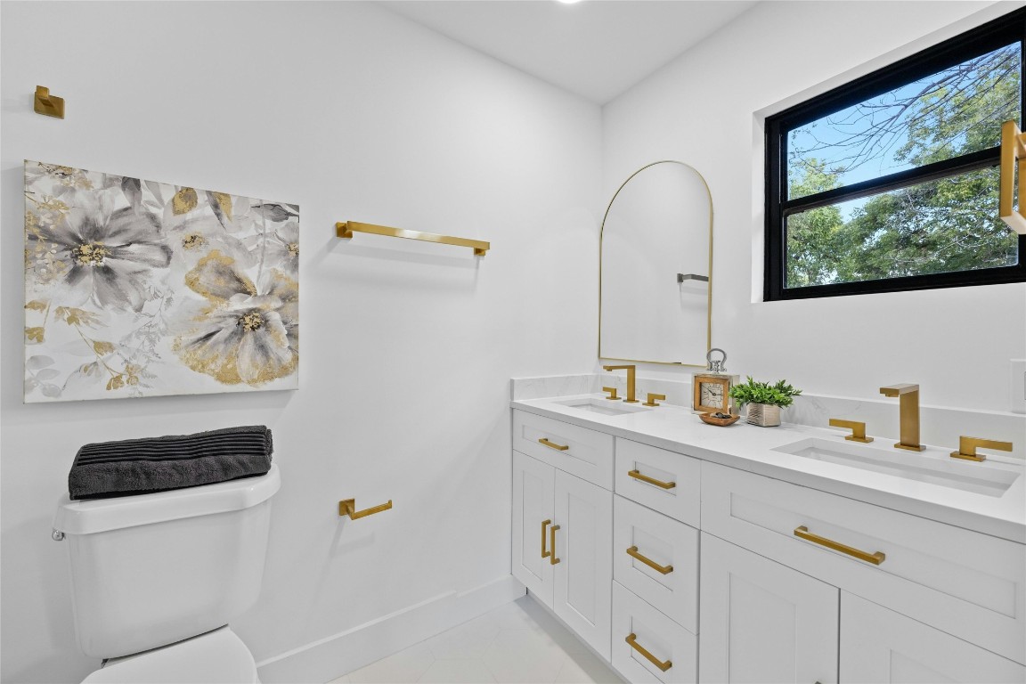 1305 Ridgehaven Drive Austin, TX 78723 - Photo 23 of 40 a bathroom with a double vanity sink and mirror