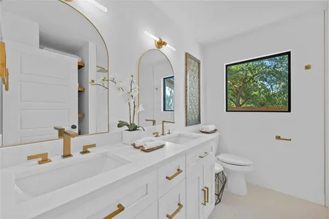 a bathroom with a double vanity sink and a mirror