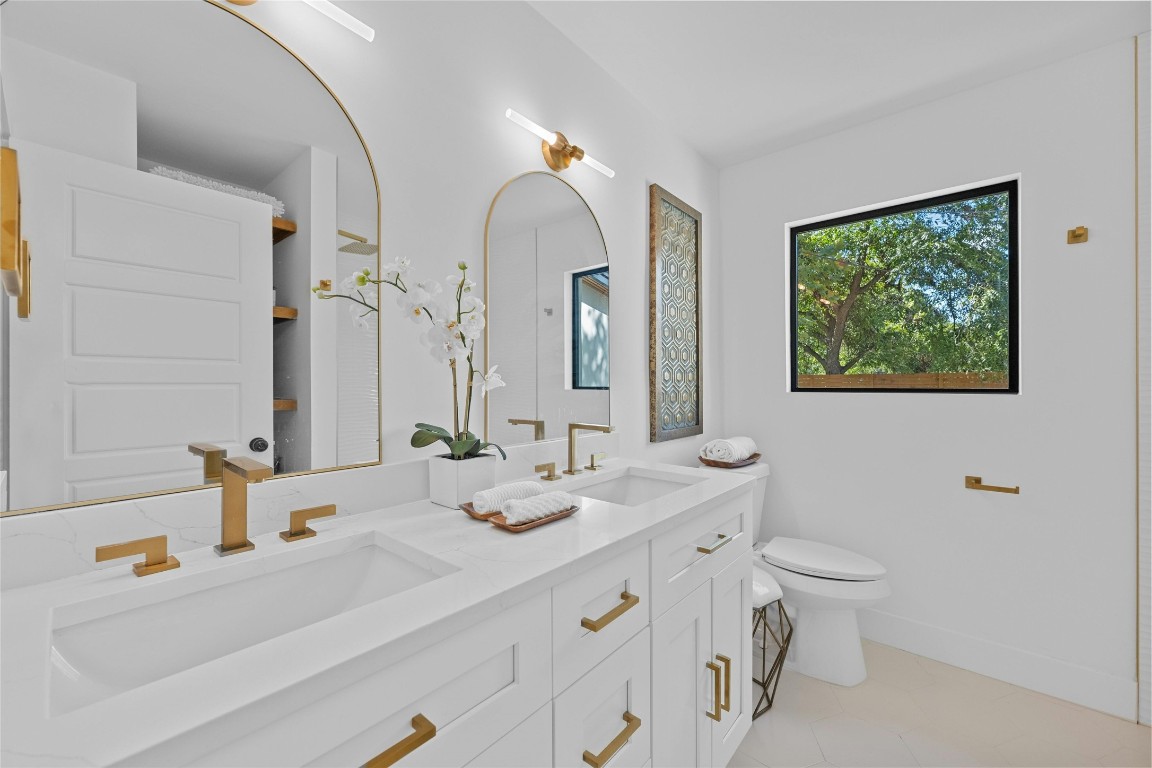 1305 Ridgehaven Drive Austin, TX 78723 - Photo 28 of 40 a bathroom with a double vanity sink and a mirror
