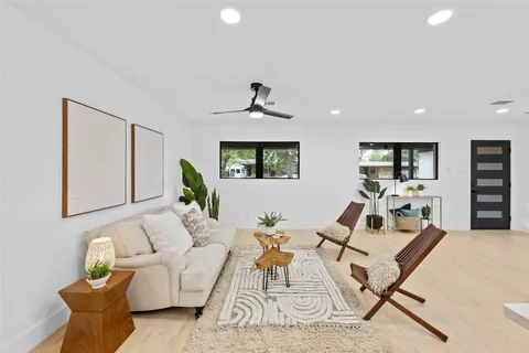 a living room with furniture and wooden floor