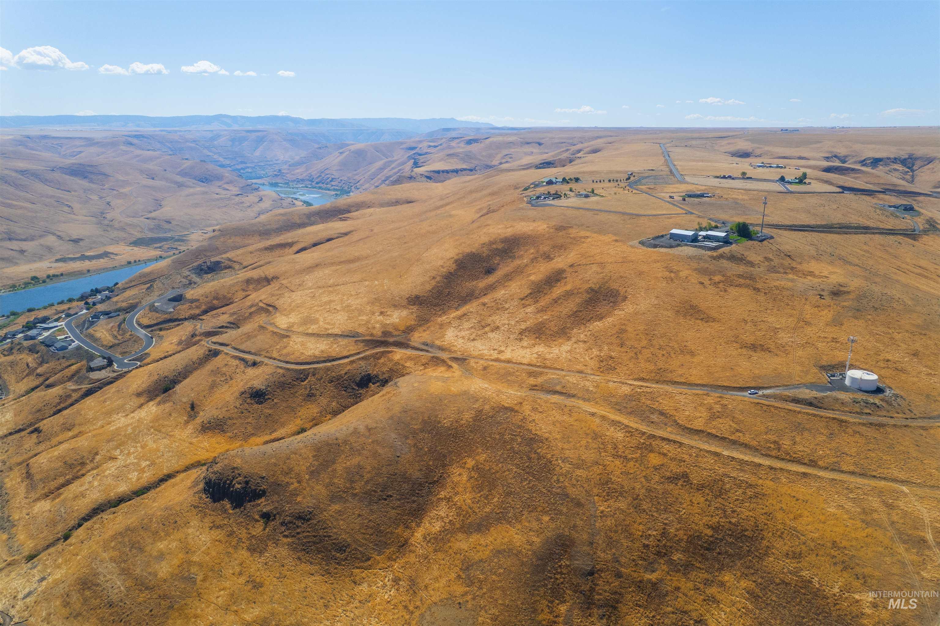 1550 Perro Pointe Road Asotin, WA 99402 - Photo 8 of 50 Aerial view of property and surrounding area with a mountain backdrop and rural landscape