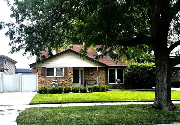 a front view of a house with a yard and porch