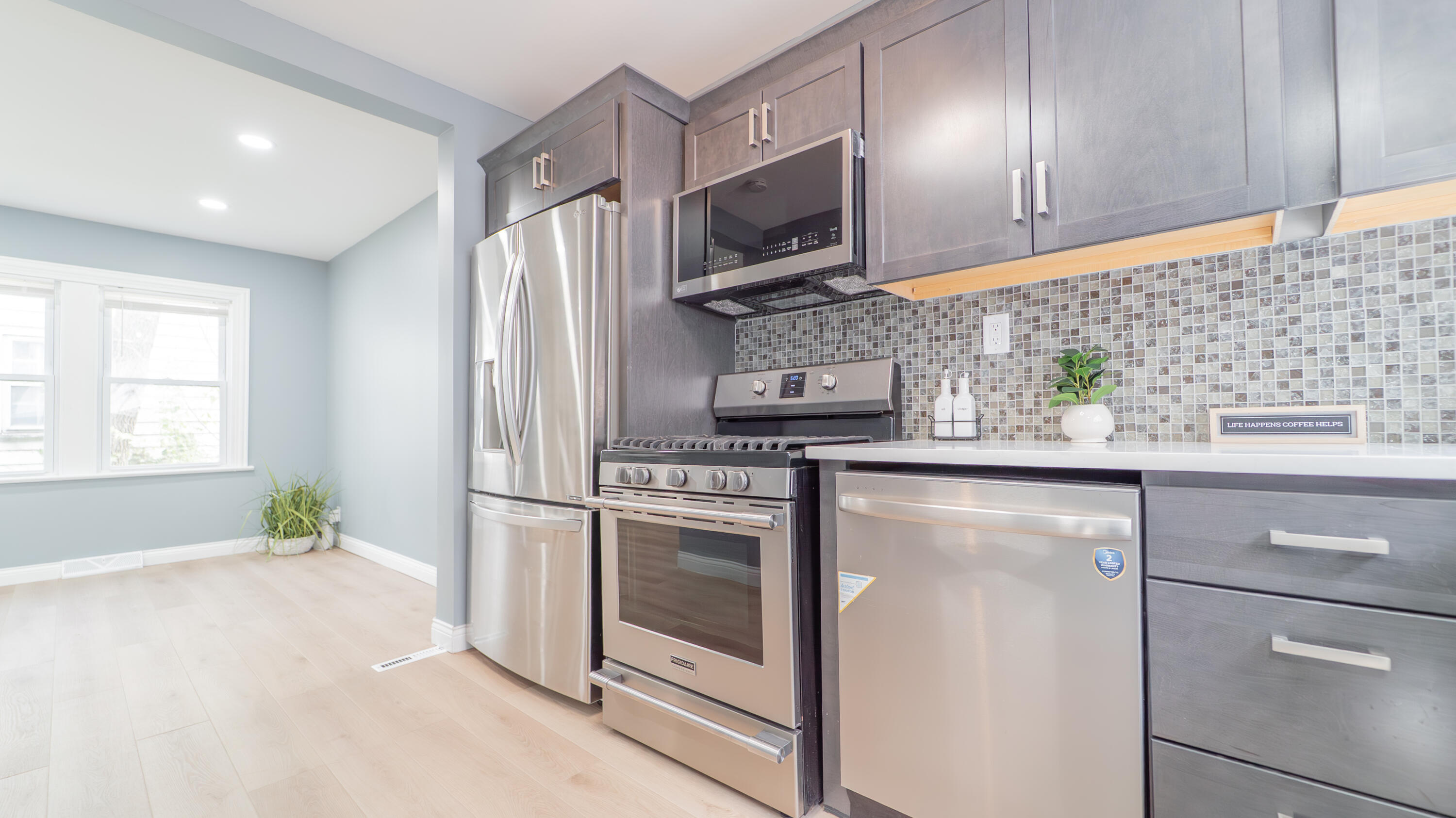 855 Fayette Street Gary, IN 46403 - Photo 11 of 25 a kitchen with stainless steel appliances granite countertop a refrigerator sink and stove