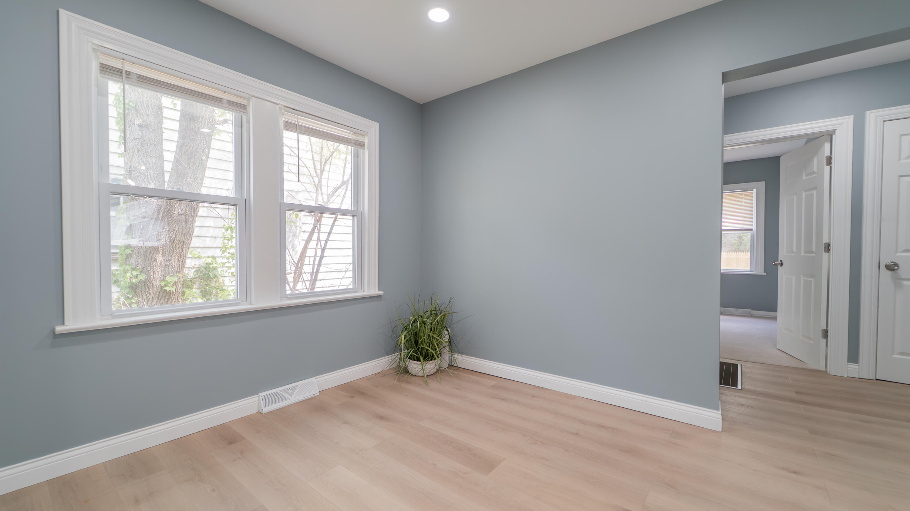 855 Fayette Street Gary, IN 46403 - Photo 12 of 25 an empty room with wooden floor and windows