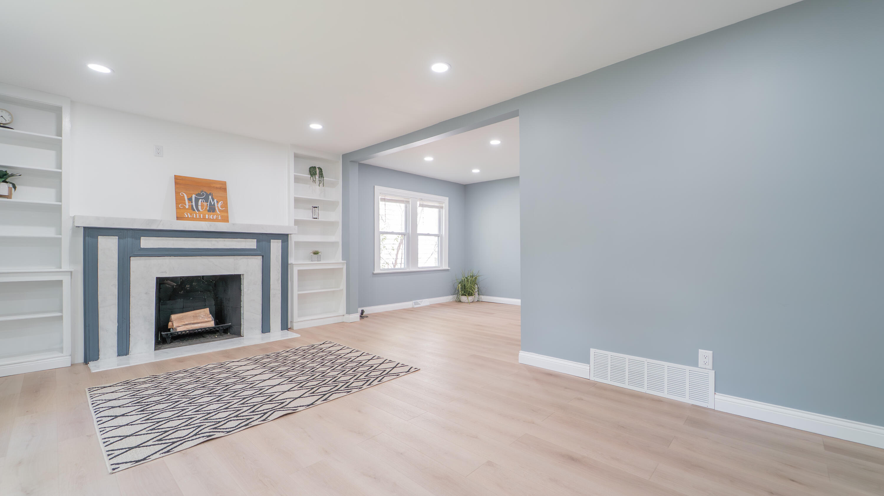 855 Fayette Street Gary, IN 46403 - Photo 5 of 25 a view of a livingroom with wooden floor a fireplace and window