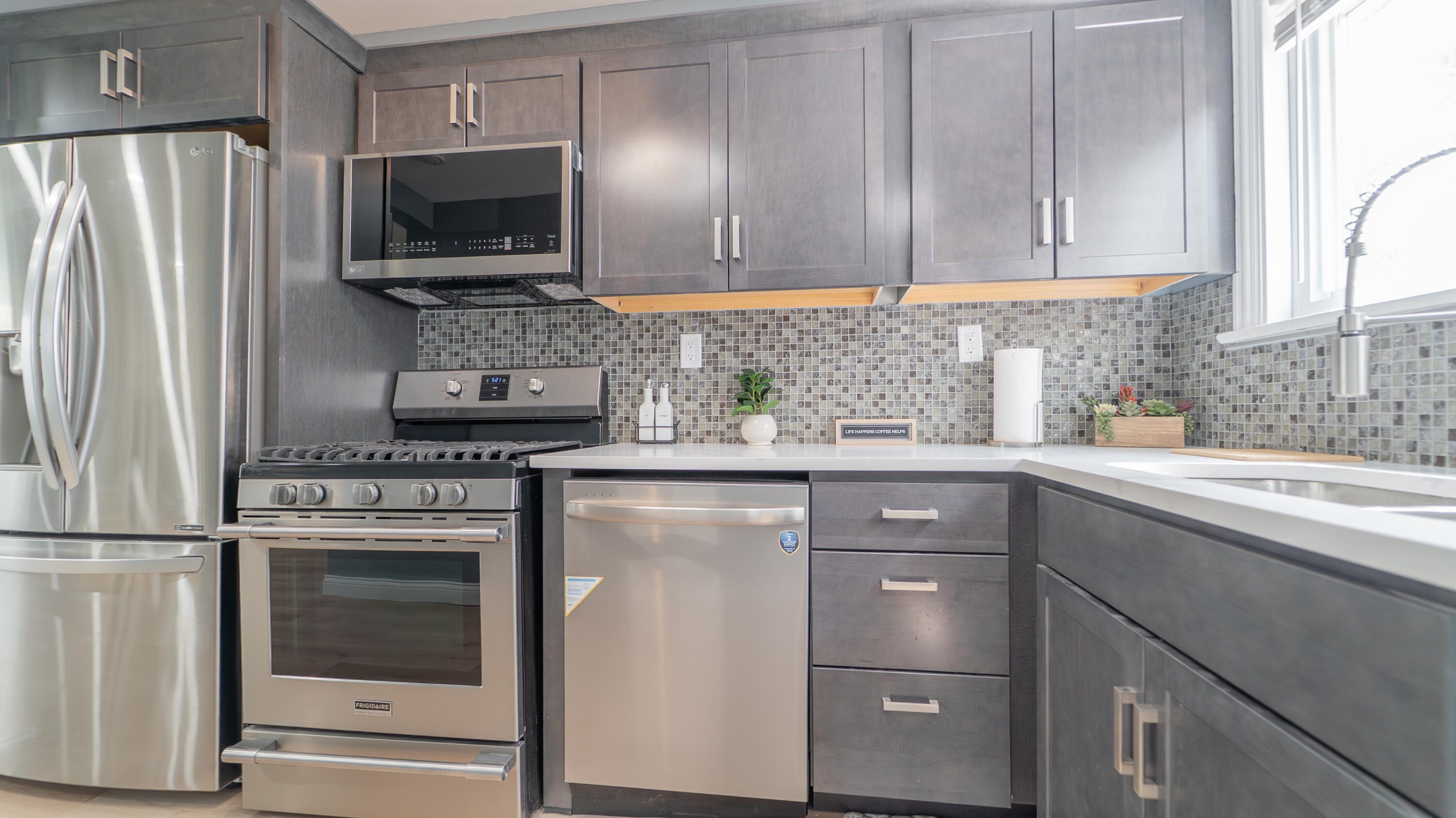 855 Fayette Street Gary, IN 46403 - Photo 9 of 25 a kitchen with appliances cabinets and a window