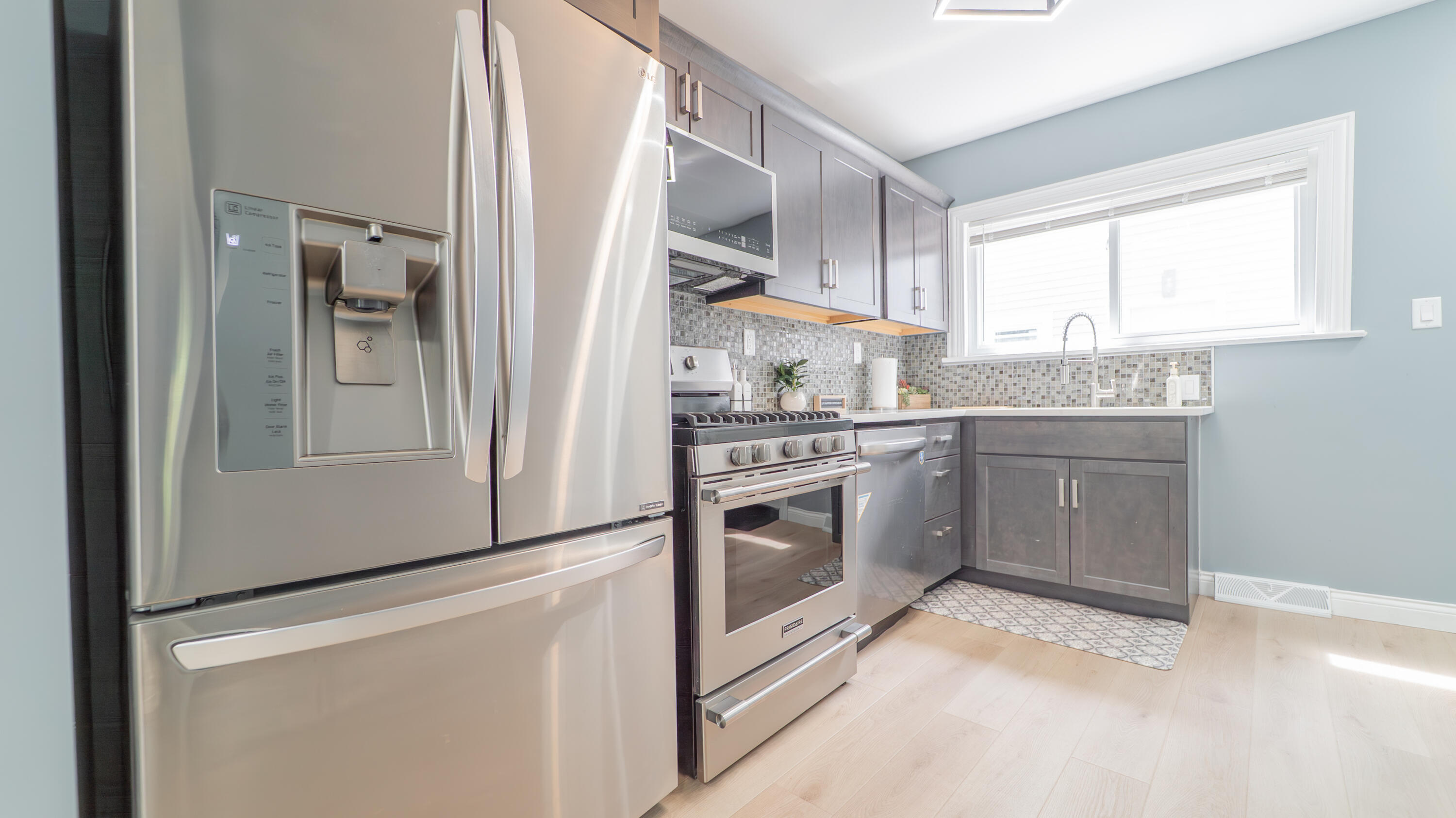 855 Fayette Street Gary, IN 46403 - Photo 10 of 25 a kitchen with stainless steel appliances granite countertop a stove a sink and a refrigerator