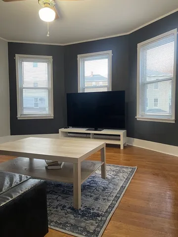 a living room with a flat screen tv and a window