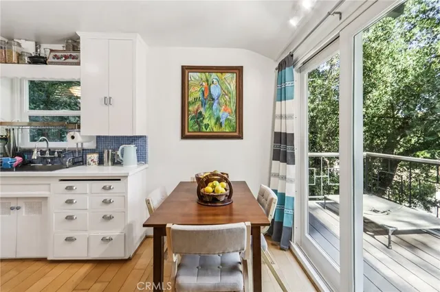 a kitchen with stainless steel appliances granite countertop a stove and a view of living room