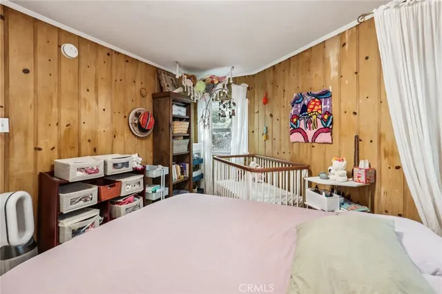 a bedroom with a bed and a large window
