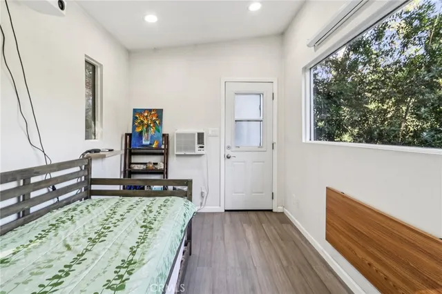a living room with hard wood flooring and a rug