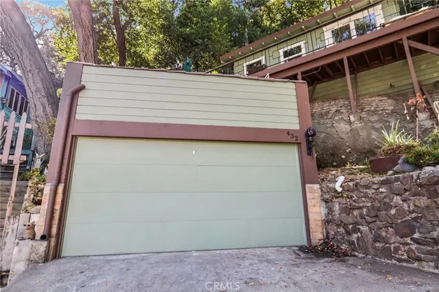 a view of a house with a door and wooden wall