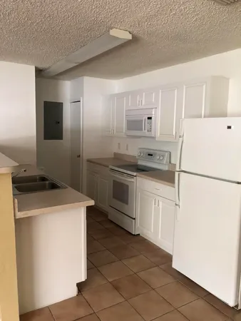 a view of a kitchen with a sink and a window