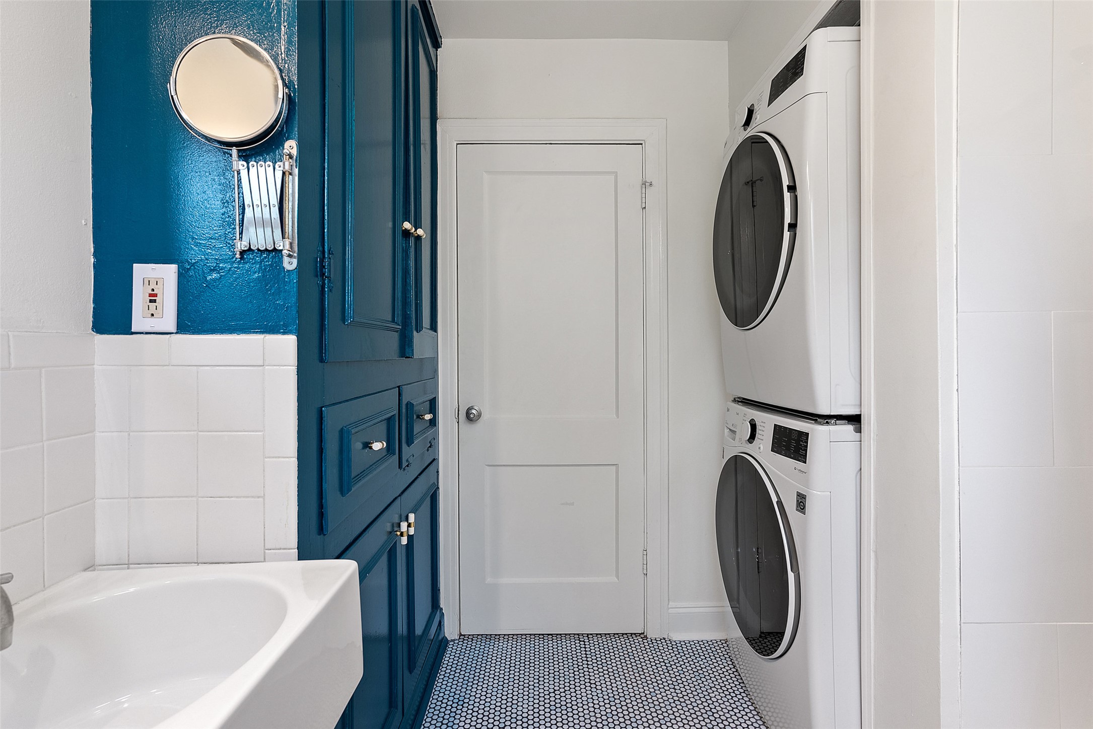 1410 Sanchez Street Austin, TX 78702 - Photo 23 of 30 Laundry room featuring tile walls, tile patterned floors, and stacked washing machine and dryer
