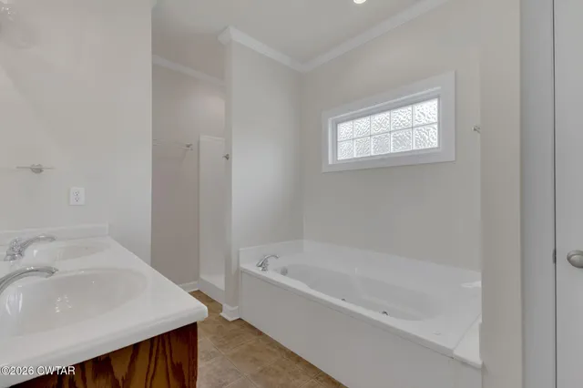 a white bath tub sitting next to a white sink