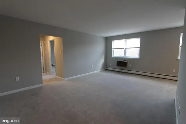 an empty room with a empty space and windows