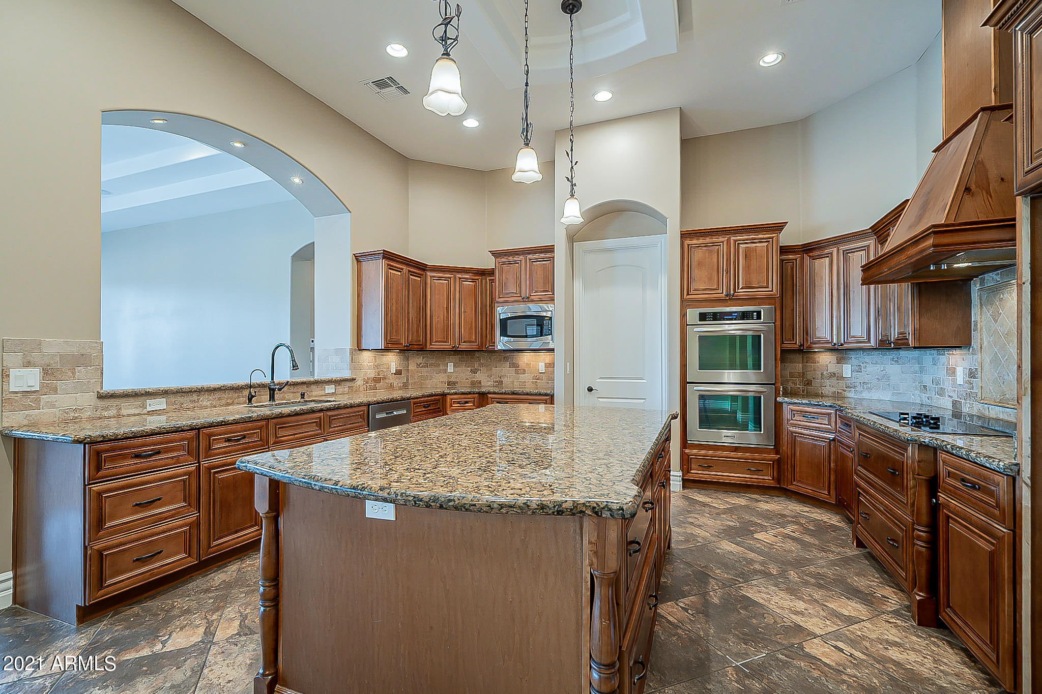2789 East Ridgewood Lane Gilbert, AZ 85298 - Photo 11 of 60 a kitchen with stainless steel appliances granite countertop a sink a stove and a wooden cabinets
