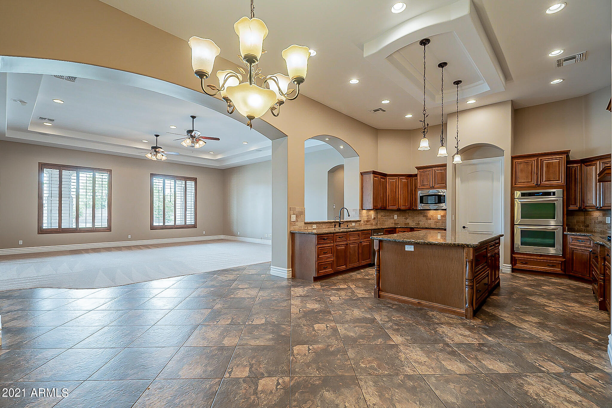 2789 East Ridgewood Lane Gilbert, AZ 85298 - Photo 16 of 60 a large kitchen with a large counter top stainless steel appliances and cabinets