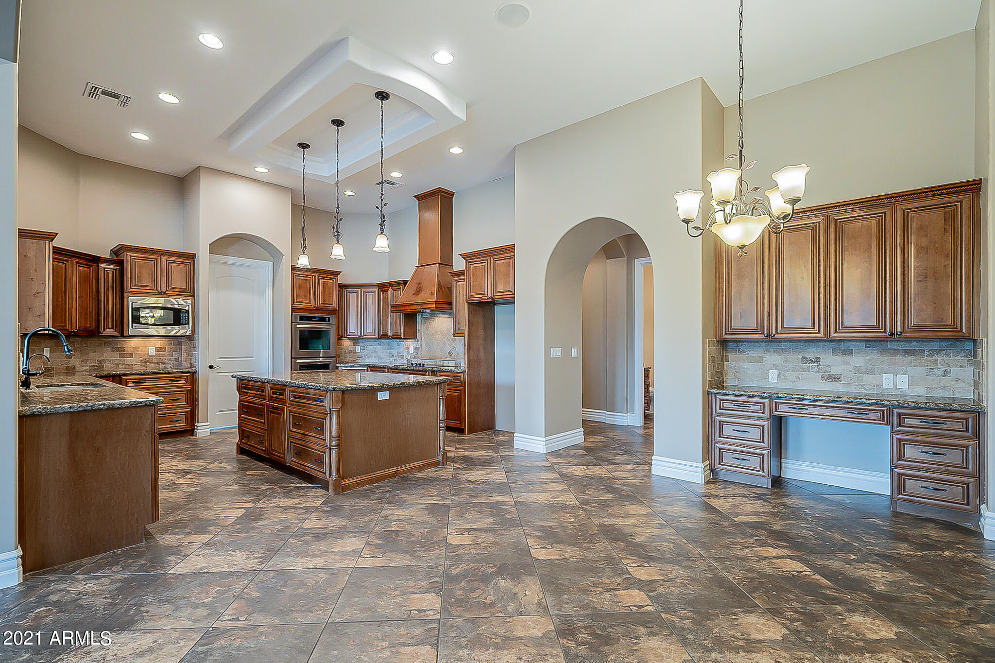 2789 East Ridgewood Lane Gilbert, AZ 85298 - Photo 17 of 60 a large kitchen with stainless steel appliances granite countertop a stove oven and a refrigerator