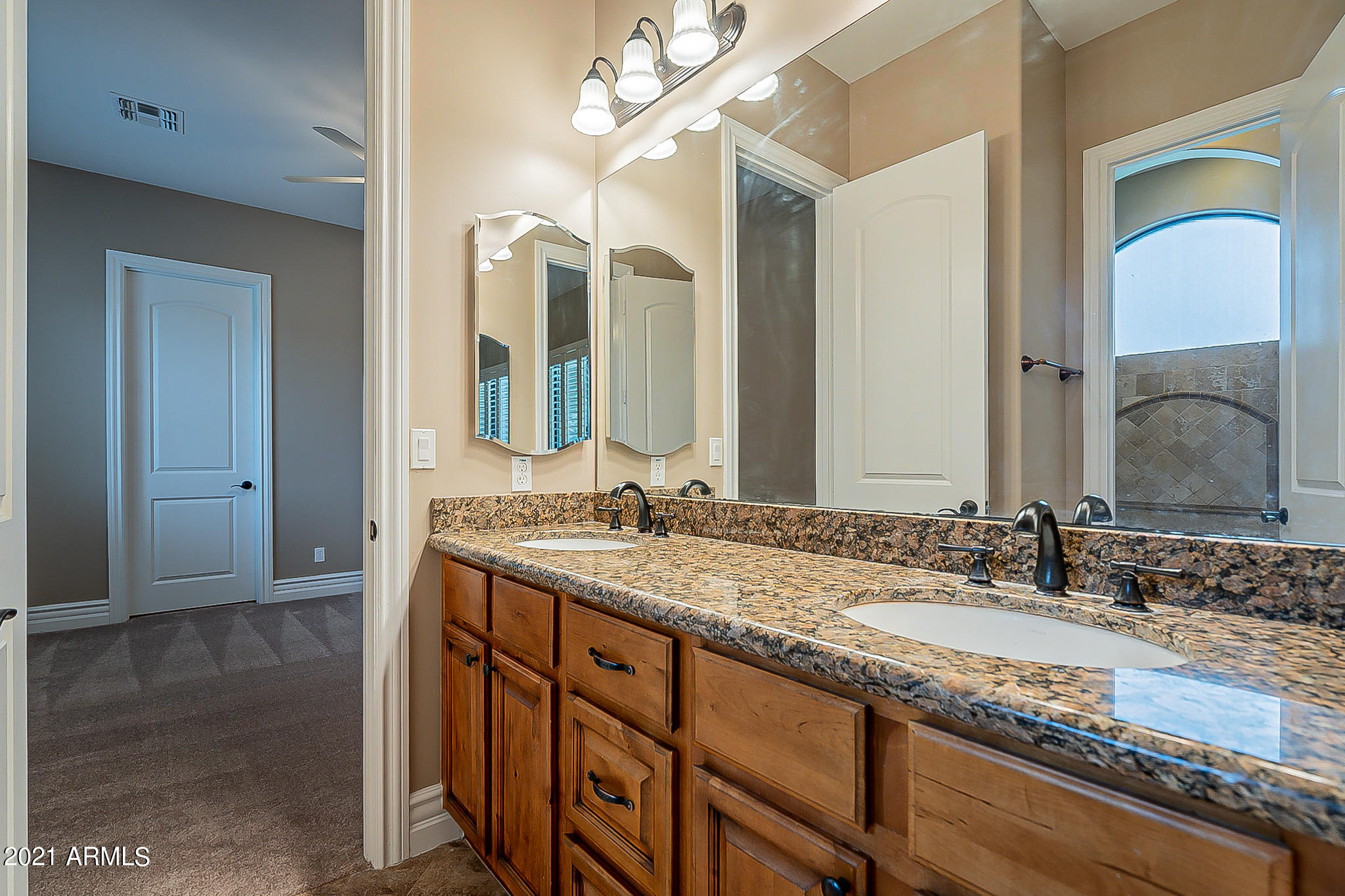 2789 East Ridgewood Lane Gilbert, AZ 85298 - Photo 32 of 60 a bathroom with a granite countertop double vanity sink and a mirror