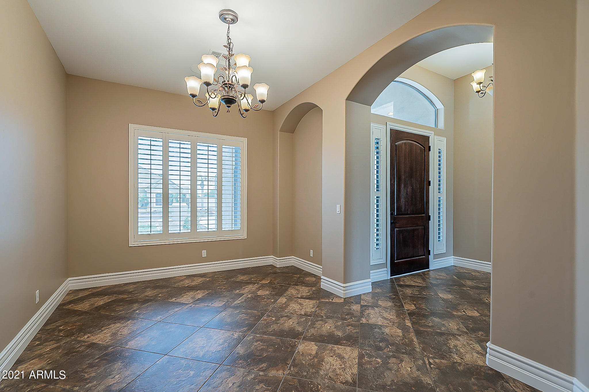 2789 East Ridgewood Lane Gilbert, AZ 85298 - Photo 7 of 60 a view of an empty room with window and chandelier