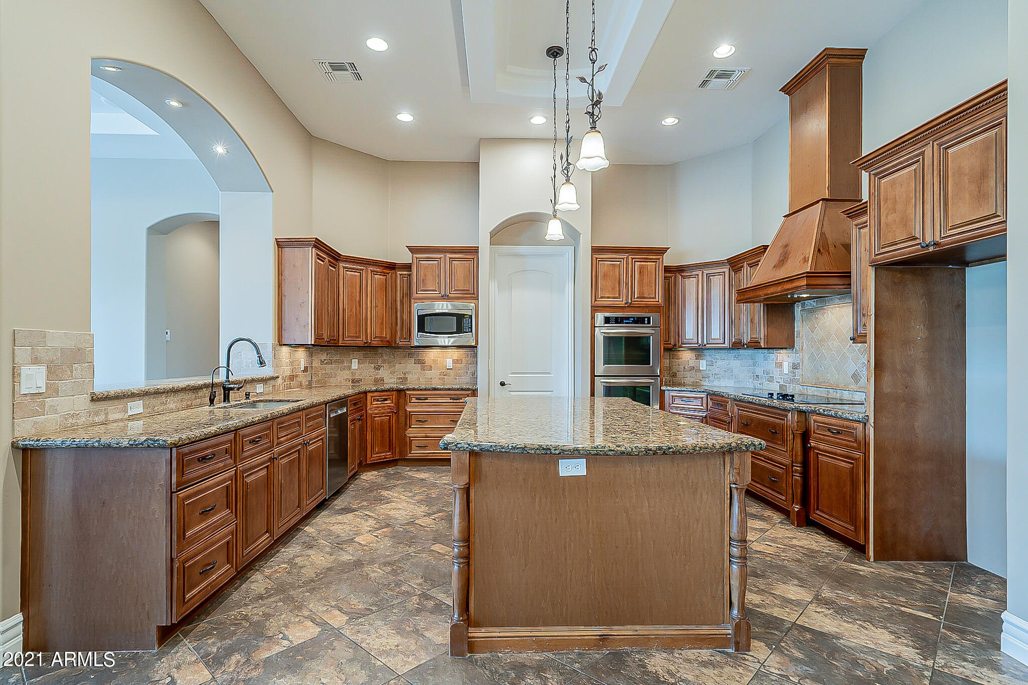2789 East Ridgewood Lane Gilbert, AZ 85298 - Photo 10 of 60 a large kitchen with stainless steel appliances kitchen island granite countertop a large counter top and stove