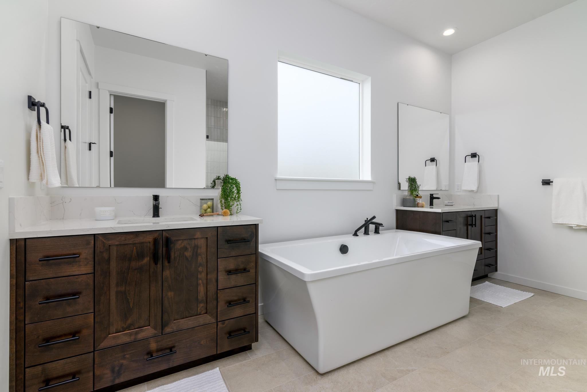 5410 Sparky Avenue Caldwell, ID 83607 - Photo 11 of 23 Bathroom with two vanities, a soaking tub, and recessed lighting
