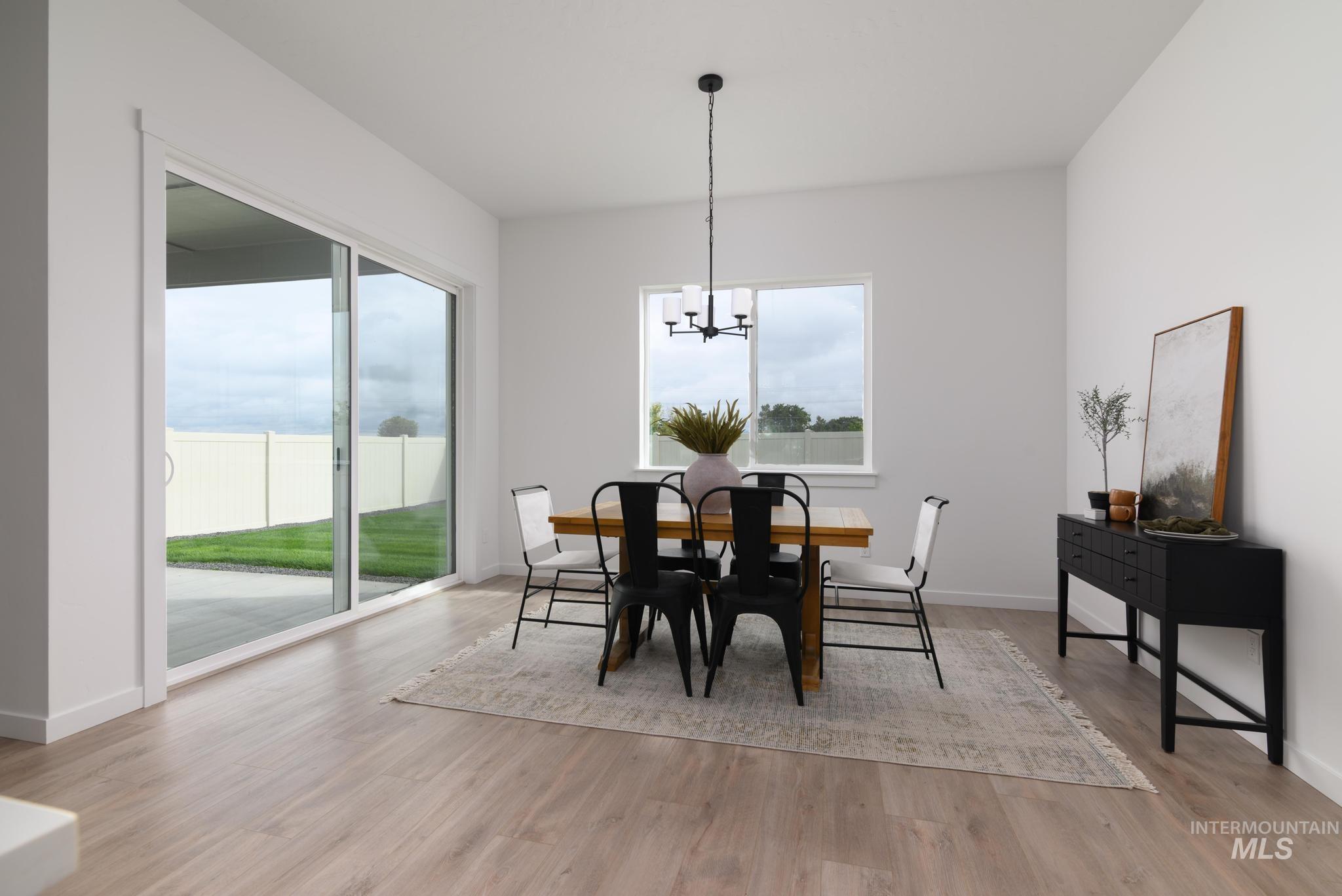 5410 Sparky Avenue Caldwell, ID 83607 - Photo 8 of 23 Dining room featuring a chandelier and light wood finished floors
