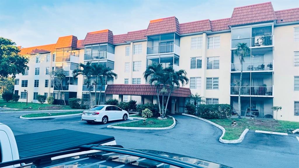 4170 Inverrary Drive, Unit 105 Lauderhill, FL 33319 - Photo 1 of 15 a front view of a house with garden