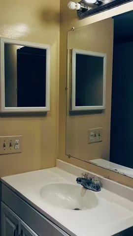 a bathroom with a sink and a mirror