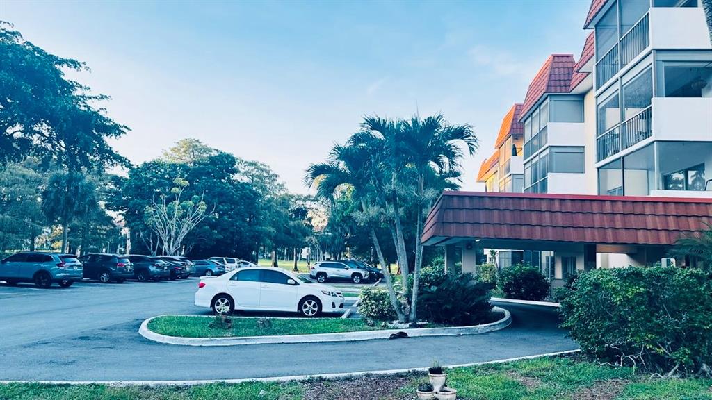 4170 Inverrary Drive, Unit 105 Lauderhill, FL 33319 - Photo 13 of 15 a view of a house with a yard and sitting area