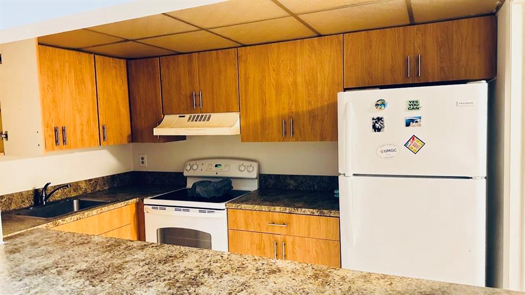 4170 Inverrary Drive, Unit 105 Lauderhill, FL 33319 - Photo 2 of 15 a kitchen with a refrigerator and a stove