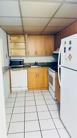 a kitchen with a white cabinets and white appliances