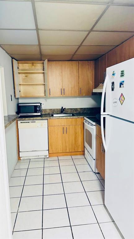 4170 Inverrary Drive, Unit 105 Lauderhill, FL 33319 - Photo 3 of 15 a kitchen with a white cabinets and white appliances