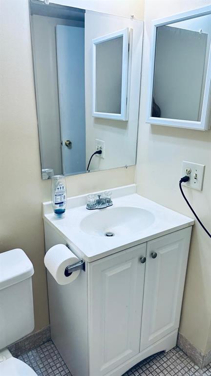 4170 Inverrary Drive, Unit 105 Lauderhill, FL 33319 - Photo 9 of 15 a bathroom with a sink toilet and mirror
