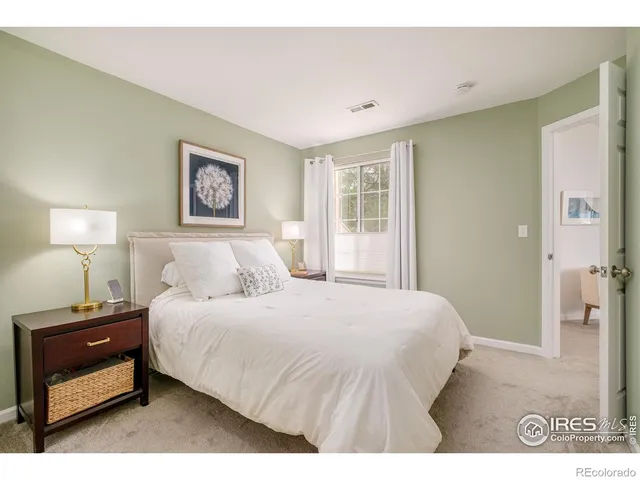 a bedroom with a bed and a lamp